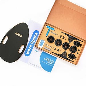 Skateboard DIY kit with tools and wheels for custom skateboarding setup.