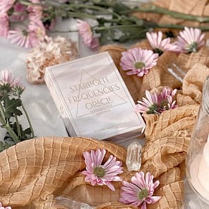 Starlight Frequencies Oracle deck with pink daisies and honeycomb paper decor.